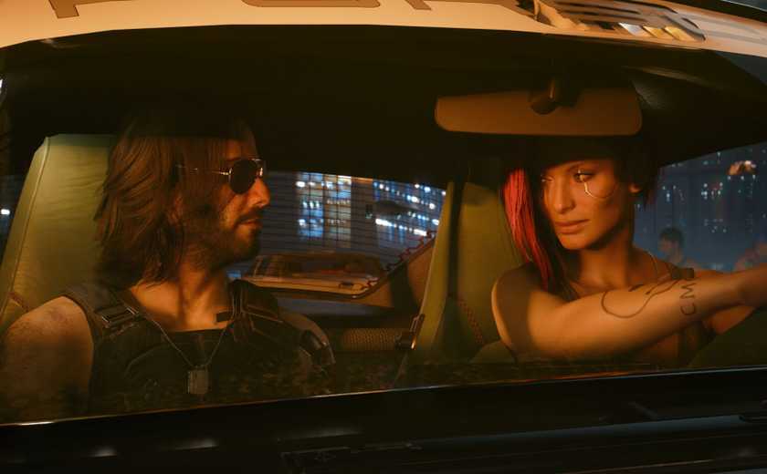 Johnny Silverhand and a female V looking at each other while V drives the car. 